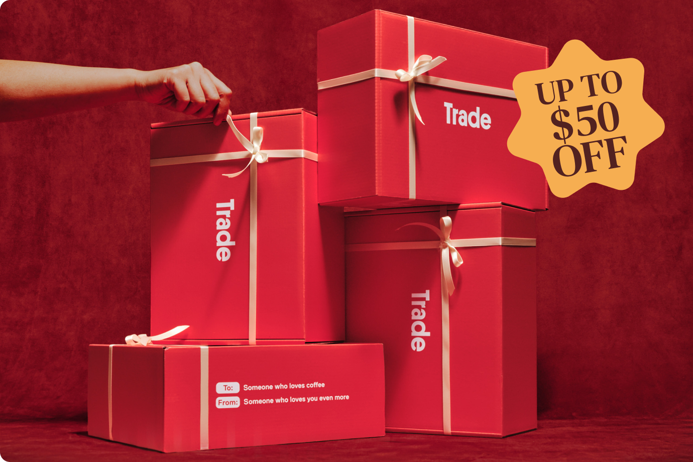 Red gift boxes with ribbons, offering up to $50 off.